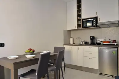 a kitchen with a table and chairs in a kitchen at Amara Porto Living in Chania Town