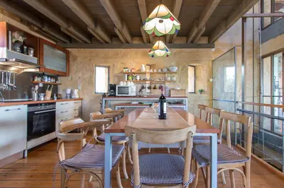 a kitchen with a wooden table and chairs at Villa Catani in Kalamaki Chanion