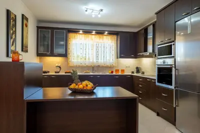 a kitchen with a bowl of fruit on a table at Villa Artemis A&B in Chania Town