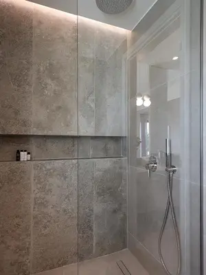 a bathroom with a shower with a glass door at Mondethea vantage point home in Chania Town