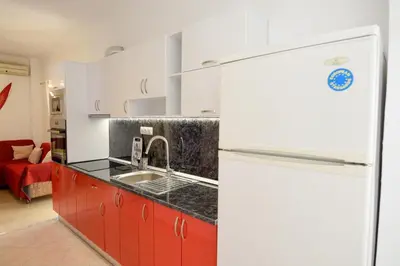 a kitchen with a white refrigerator and a sink at Rubini City Apartment in Chania Town