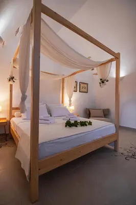 a bedroom with a large bed with a canopy at Marthas DeLight Rooms in Chania Town