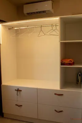 a white closet with white drawers and a tv at Tabak home Sea side apartment in Chania Town