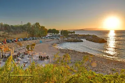a beach with a crowd of people on the shore at Tabak home Sea side apartment in Chania Town