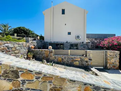 a stone wall with a building on top of it at Pink Sand-Studio in Agios Padeleimon