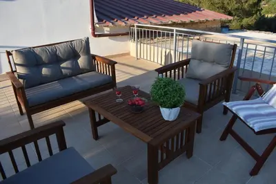 a patio with two chairs and a table and a couch at Ioannis Home at Skonizo in Chania Town