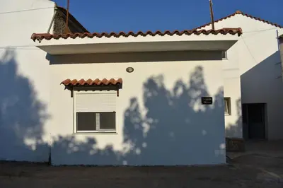 a white building with a window and a shadow at Ioannis Home at Skonizo in Chania Town