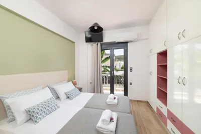 a bedroom with a white bed with towels on it at Villa Gianta in Kissamos