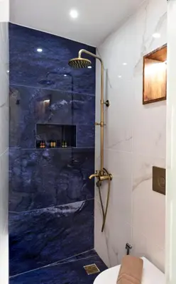a bathroom with a shower with a blue marble wall at La 'belle Luxury House Chania in Chania Town