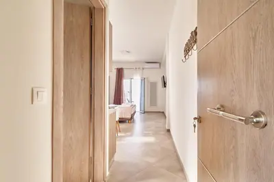 an open door to a hallway with a room at Adele Apartment in Kissamos