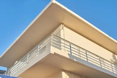 a balcony of a building with a blue sky in the background at Bella Apartment in Kissamos