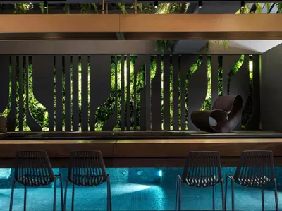 a view of a pool with chairs and a fence at The Chania Hotel Crete, Vignette Collection in Chania Town