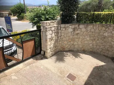 a stone wall with a gate and a fence at Villa Harriet Maria with pool and ocean view Kolimbari, Chania in Kolymvari