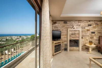 a living room with a view of the ocean at Caneva Luxury Villa in Tavronitis