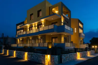 a building with lights in front of it at night at Evriali Comfort Living in Palaiochóra