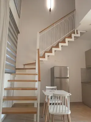 a staircase in a house with two chairs and a table at Evriali Comfort Living in Palaiochóra
