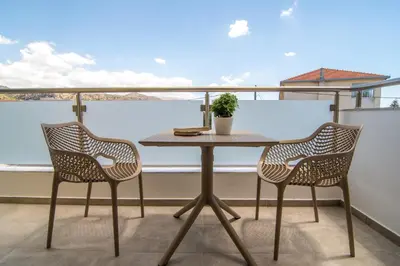 a table and two chairs on a balcony at Evriali Comfort Living in Palaiochóra