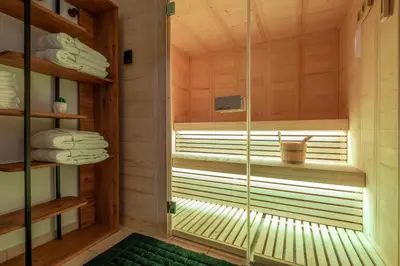a sauna with a window with towels in it at Delight Luxury Residences - Souda in Souda