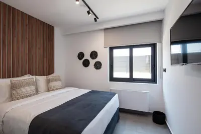 a bedroom with a large bed and a window at Horizon Luxury Villa in Chania Town