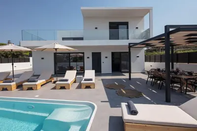a patio with a swimming pool and a house at Horizon Luxury Villa in Chania Town