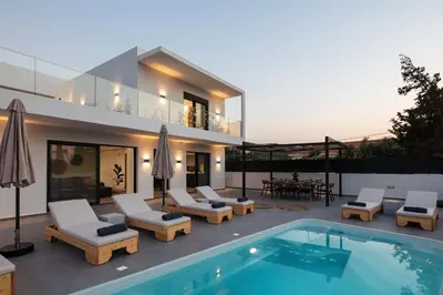 a villa with a swimming pool and a house at Horizon Luxury Villa in Chania Town