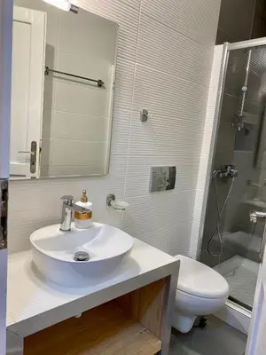 a white bathroom with a sink and a toilet at RITSA ART RESIDENCE in Chania Town