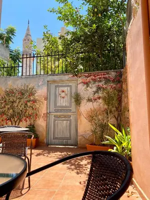 a door in a wall with a table and chairs at RITSA ART RESIDENCE in Chania Town