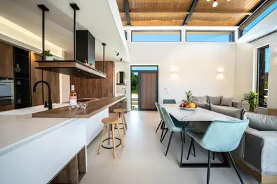 a kitchen and living room with a table and chairs at Villa Olira in Alikianós