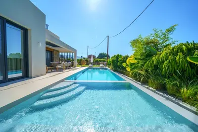 a swimming pool in the backyard of a house at Villa Olira in Alikianós