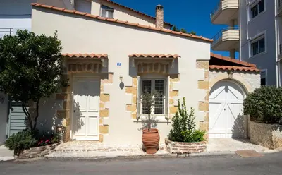 a white house with a white door and a tree at casa di nonna in Chania Town