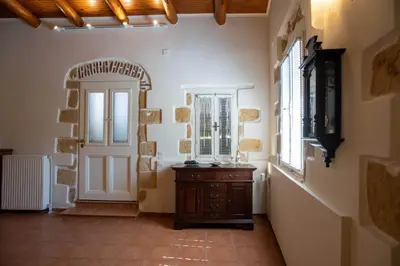 a hallway with a wooden dresser and a door at casa di nonna in Chania Town