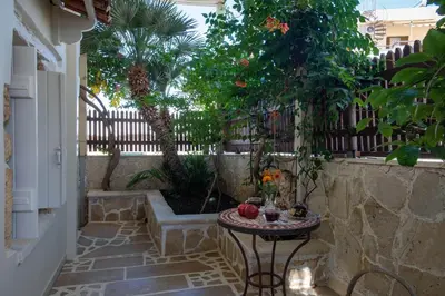 a small patio with a table and a fence at casa di nonna in Chania Town