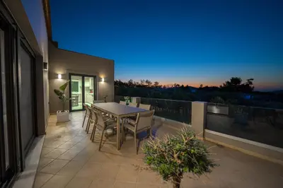 a patio with a table and chairs on a balcony at Villa Florentina at Chania Suburbs With Private Pool and BBQ in Alikianós