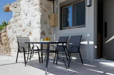 a table and chairs sitting on a patio at Thea Studio in Agios Padeleimon
