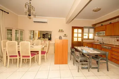 a kitchen with a table and chairs and a refrigerator at Strevagio family house in Kissamos
