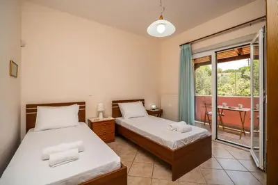 a bedroom with two beds and a balcony at Villa Silva, Garden & Sea View, 3 BR, -10 min drive from center in Chania Town