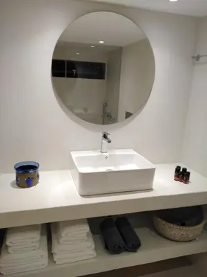 a bathroom with a white sink and a mirror at Fourteen All Seasons House in Chania Town