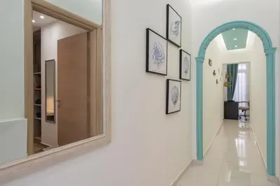 a hallway with a mirror and an archway at Luxury Pearl, steps to the beach in Chania Town
