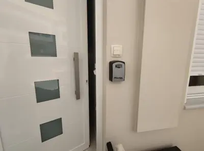 a white door with a cell phone on it at Luxury Pearl, steps to the beach in Chania Town