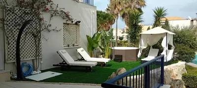 a yard with two chairs and a gazebo at Villa Rodo in Pírgos Psilonérou