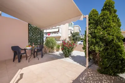 a patio with a table and chairs and plants at Peris #1 - Souda in Souda