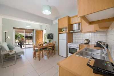 a kitchen with a sink and a table in it at Peris #1 - Souda in Souda