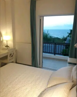 a bedroom with a bed and a view of the ocean at Ocean View in Chania Town