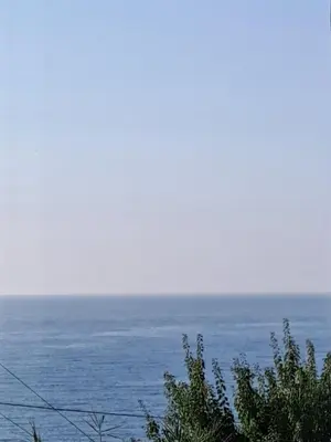 a view of the ocean with trees in the foreground at Ocean View in Chania Town