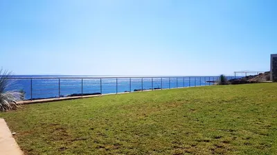 a view of the ocean from a park at Kritamos Beach Apartments in Frangokastello
