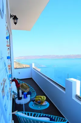 a room with a balcony with a view of the water at Panorama Sea View Apartment in Beritianá