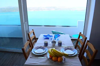 a table with plates of bananas and oranges on it at Panorama Sea View Apartment in Beritianá