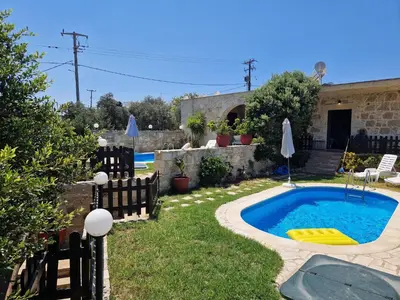 a backyard with a swimming pool and a house at VILLA MICHAELA in Gramvousá