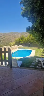 a swimming pool with a bench and a fence at VILLA MICHAELA in Gramvousá