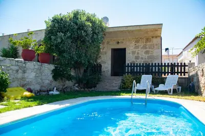 a swimming pool with two chairs in a yard at VILLA MICHAELA in Gramvousá